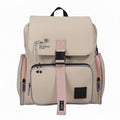 Mochila WISHFUL de nylon en color beige con solapa frontal, hebilla rosa, bolsillos laterales y detalle de imperdible